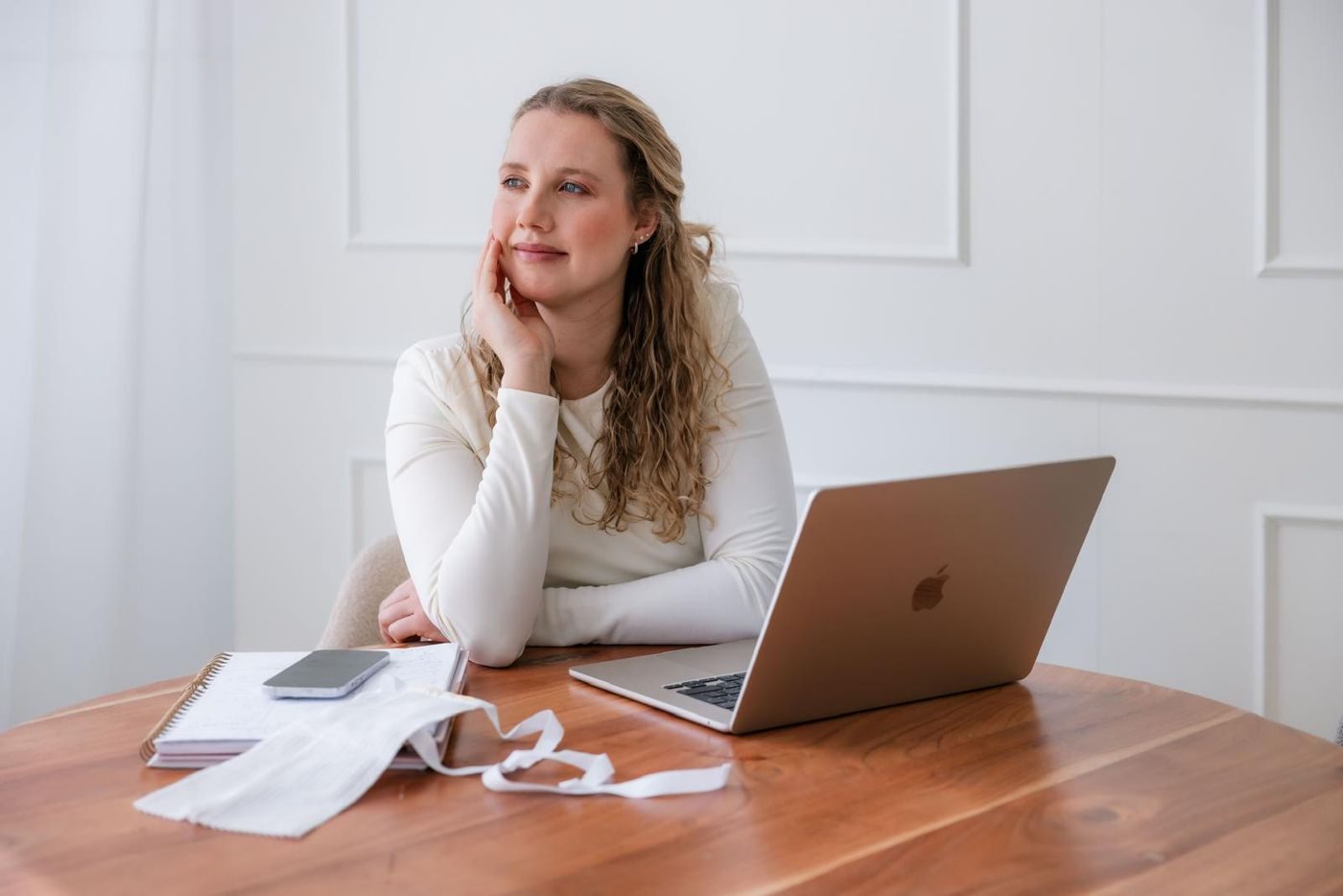 Debra Bekker aan tafel met haar laptop en aantekeningen